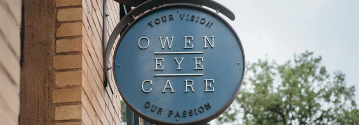 The sign outside the Owen Eye Care clinic bearing the clinic logo and tagline